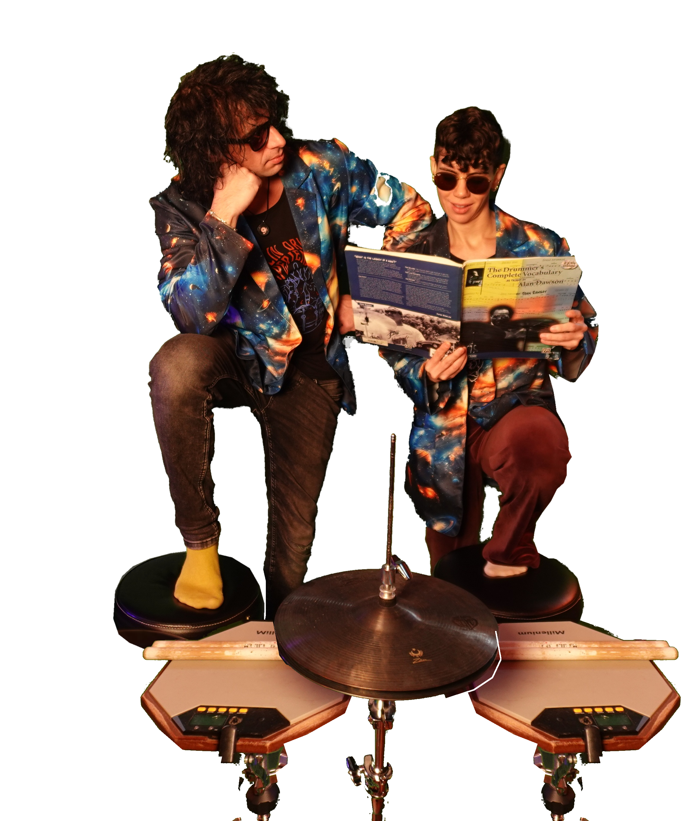 Marco and Natasha in their galaxy jackets, reading a drum book together above their practice pads and cymbal.